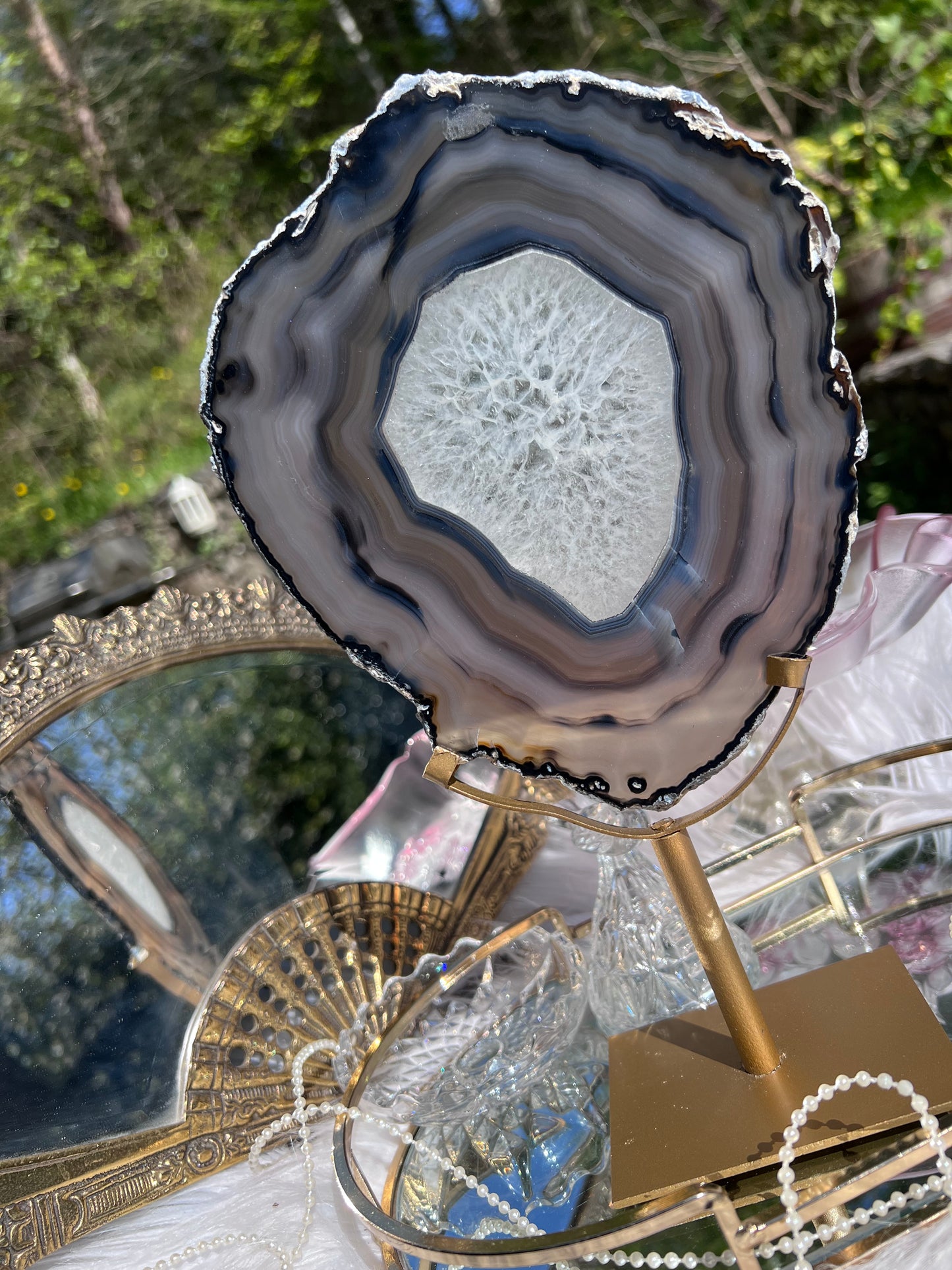 Black Agate portal with clear Quartz centre on Gold Metal stand